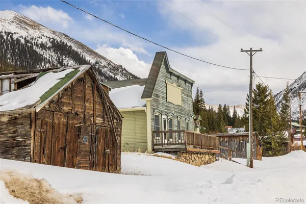 a view of a house with a snow on the road