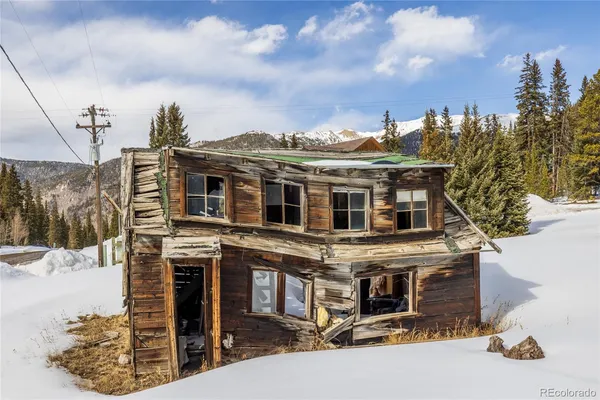 a view of a house with a snow in the background