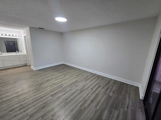 a bathroom with a sink vanity and mirror