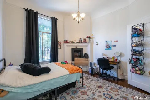 a view of living room with large windows and plants