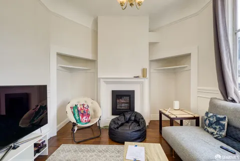a spacious bedroom with a bed and a chandelier