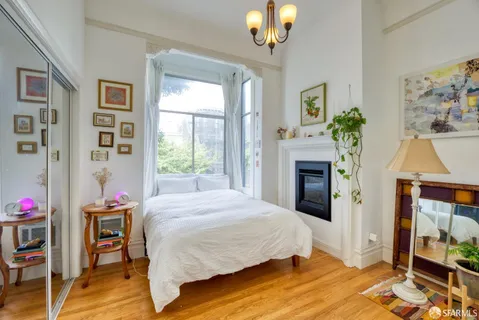 a bedroom with a bed and a fireplace