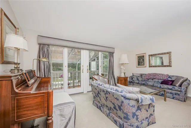 a bedroom with furniture and a large window