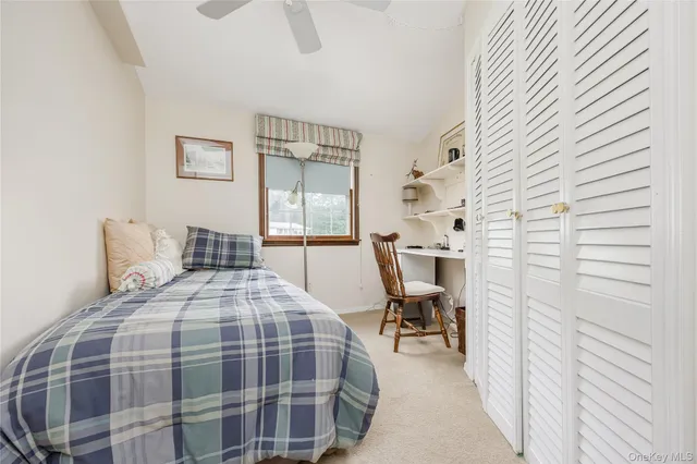 a bedroom with a bed a table and chair