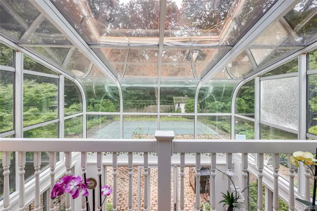 a view of a balcony with yard