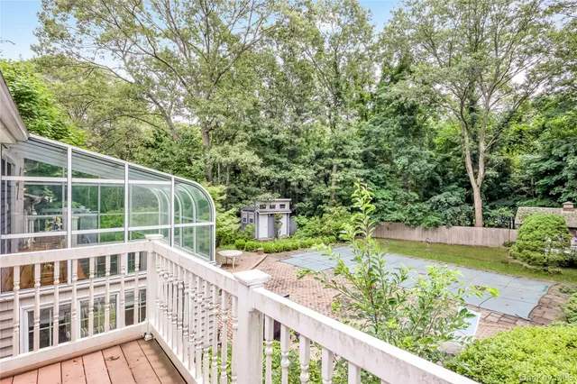 a view of white house with a yard and potted plants