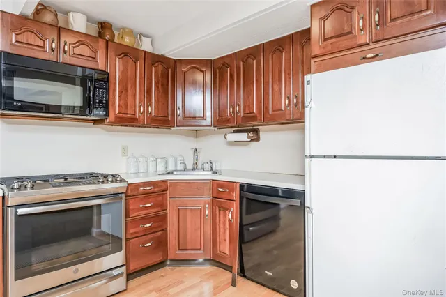 a kitchen with stainless steel appliances granite countertop a stove microwave and cabinets