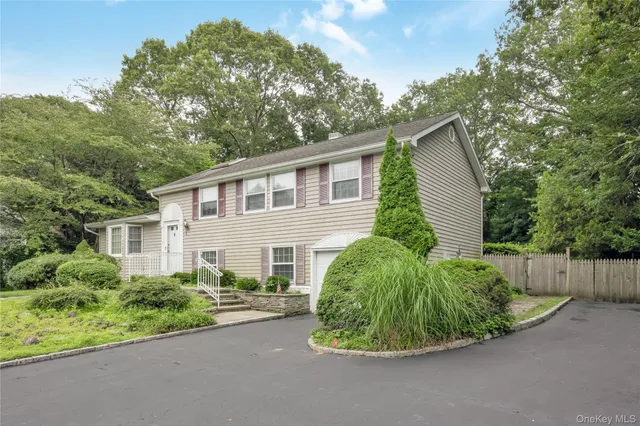 a view of a house with a yard and plants