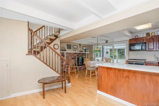 a dining room with furniture entryway and wooden floor