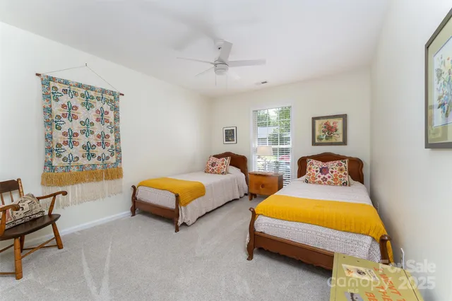 a bedroom with furniture and a large window