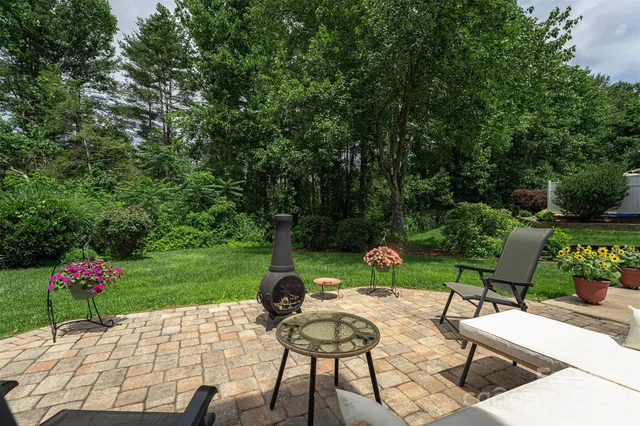 a view of a backyard with sitting area