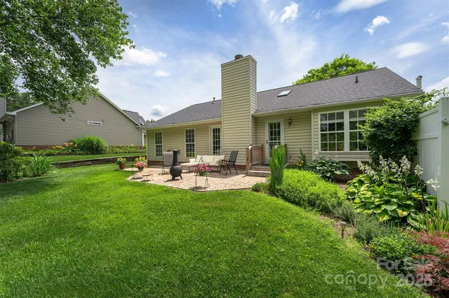 a view of a house with sitting area and garden