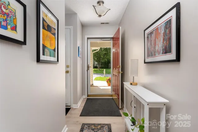 a hallway with a painting on the wall