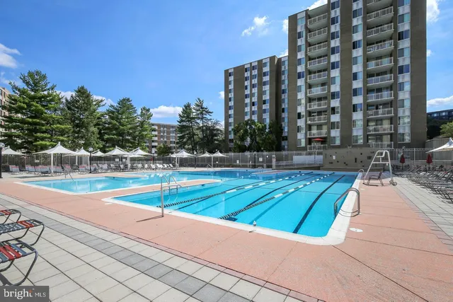 a view of swimming pool with outdoor seating and yard