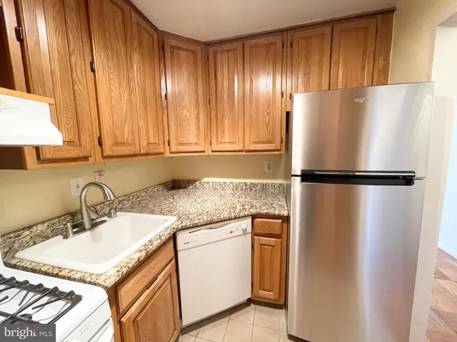 a kitchen with a refrigerator and a sink