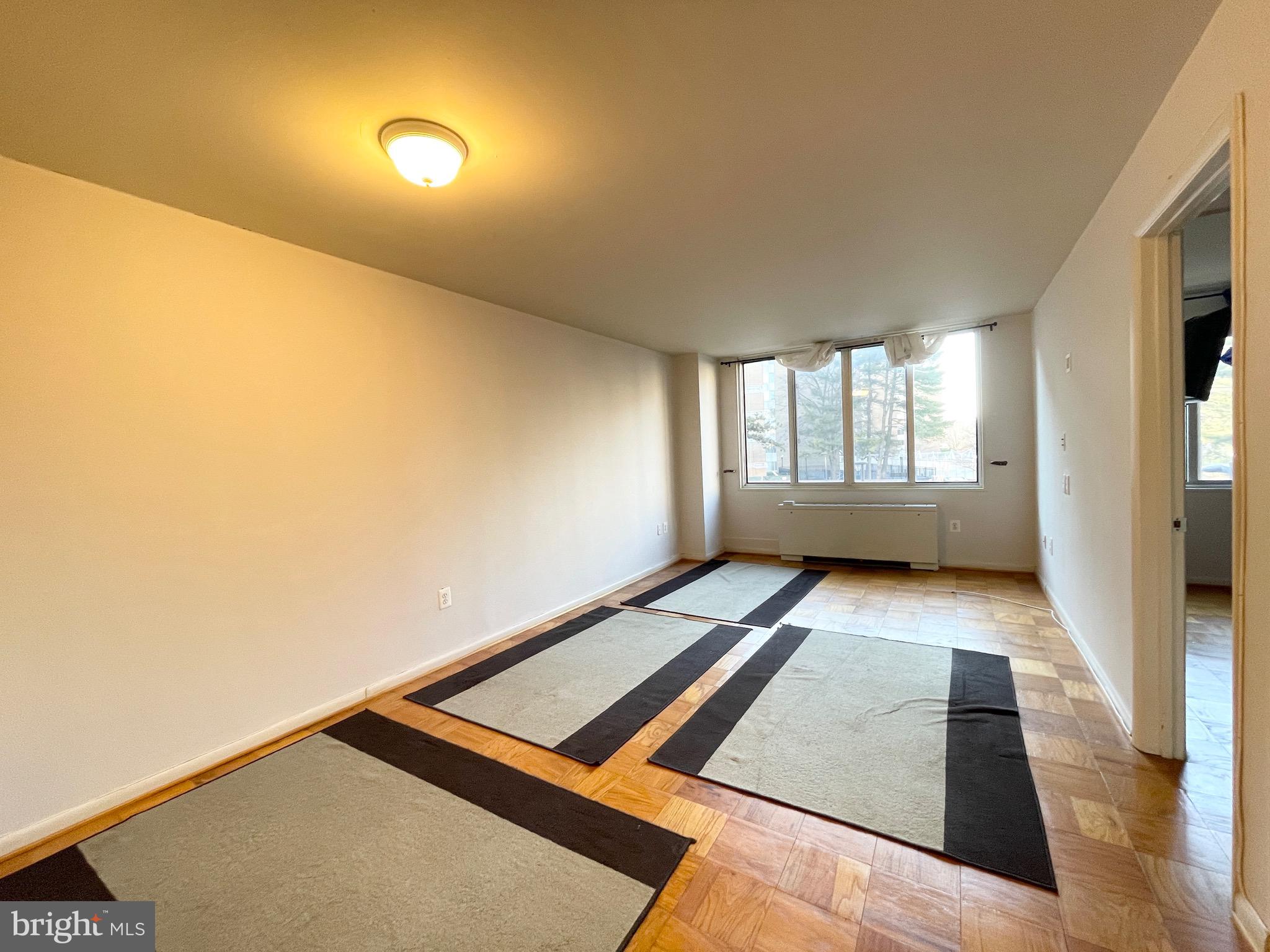 2939 Van Ness Street Northwest, Unit 737 Washington, DC 20008 - Photo 4 of 18 a view of an empty room and window