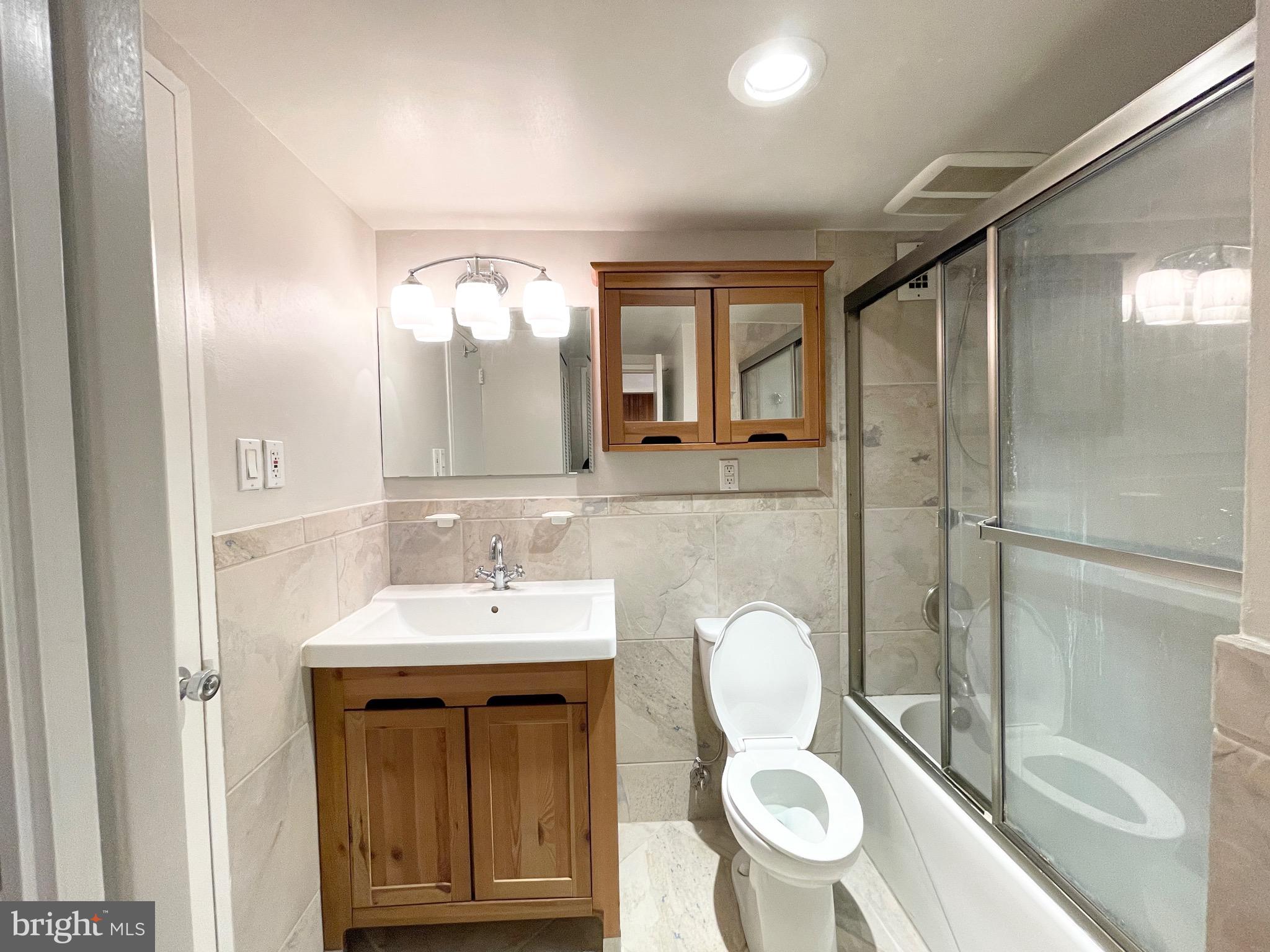 2939 Van Ness Street Northwest, Unit 737 Washington, DC 20008 - Photo 6 of 18 a bathroom with a sink a toilet and shower