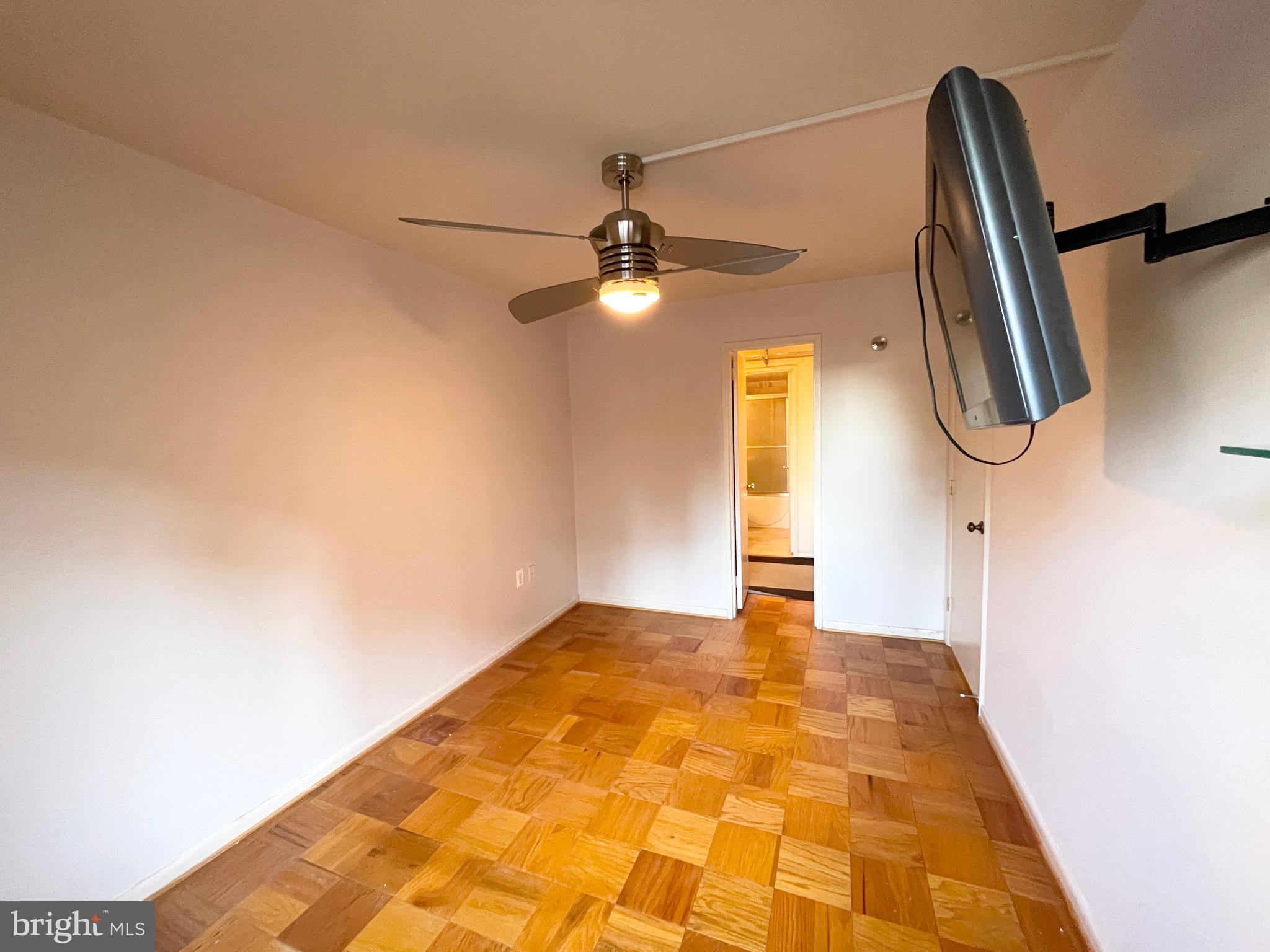 2939 Van Ness Street Northwest, Unit 737 Washington, DC 20008 - Photo 10 of 18 a bedroom with a bed and a chandelier