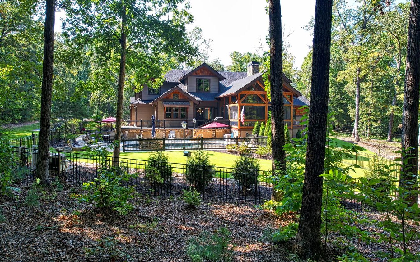 783 Eaton Road Blue Ridge, GA 30513 - Photo 8 of 64 a front view of a house with swimming pool lawn chairs and lake view