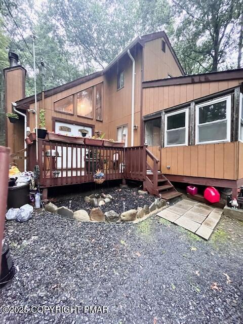 a view of a house with a yard and wooden fence