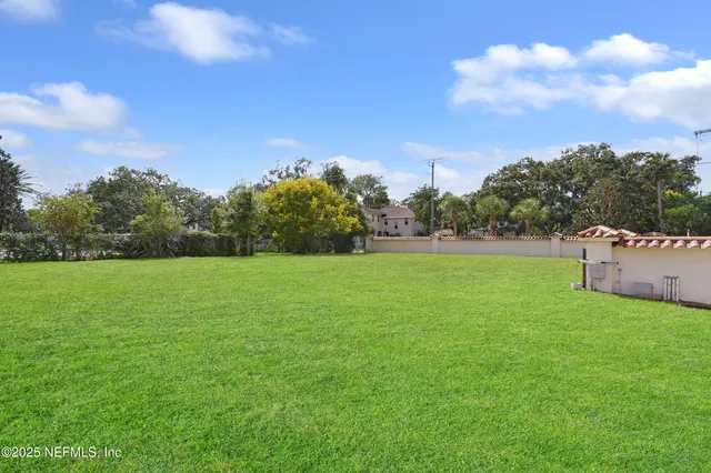 a view of a park with large trees and a big yard
