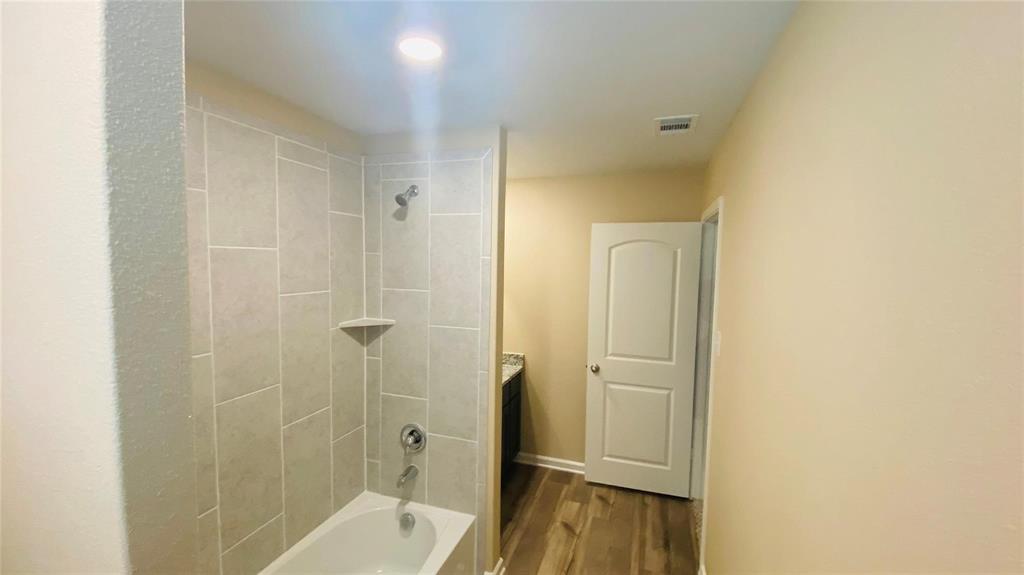 261 Moonstone Way Princeton, TX 75407 - Photo 6 of 9 a bathroom with a bathtub and a shower