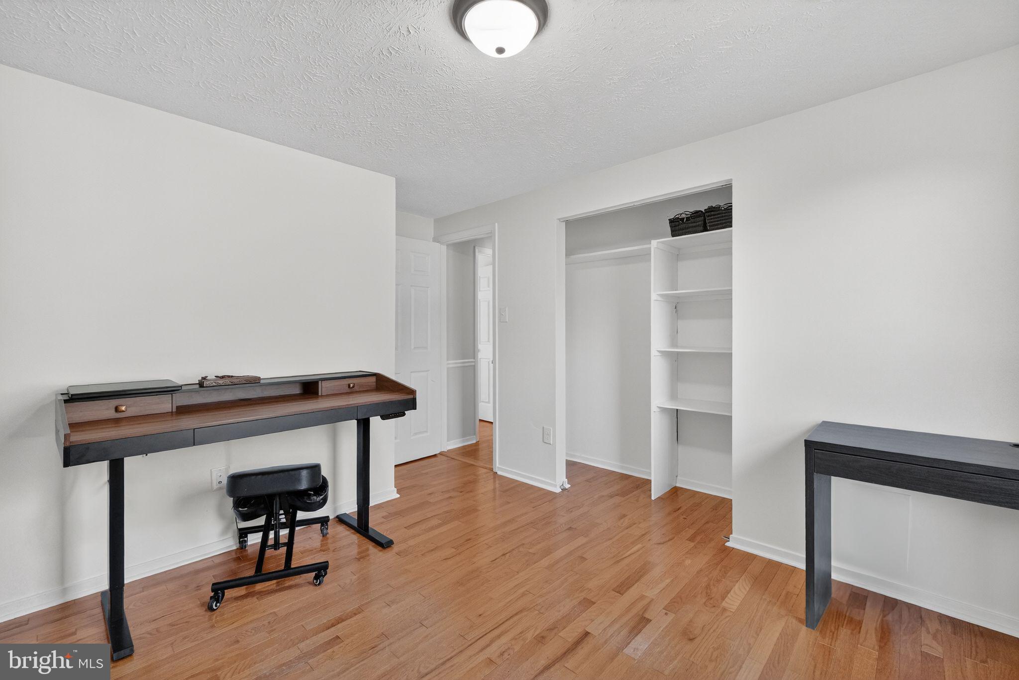 12608 Carland Place Laurel, MD 20708 - Photo 15 of 38 a view of room with wooden floor and windows