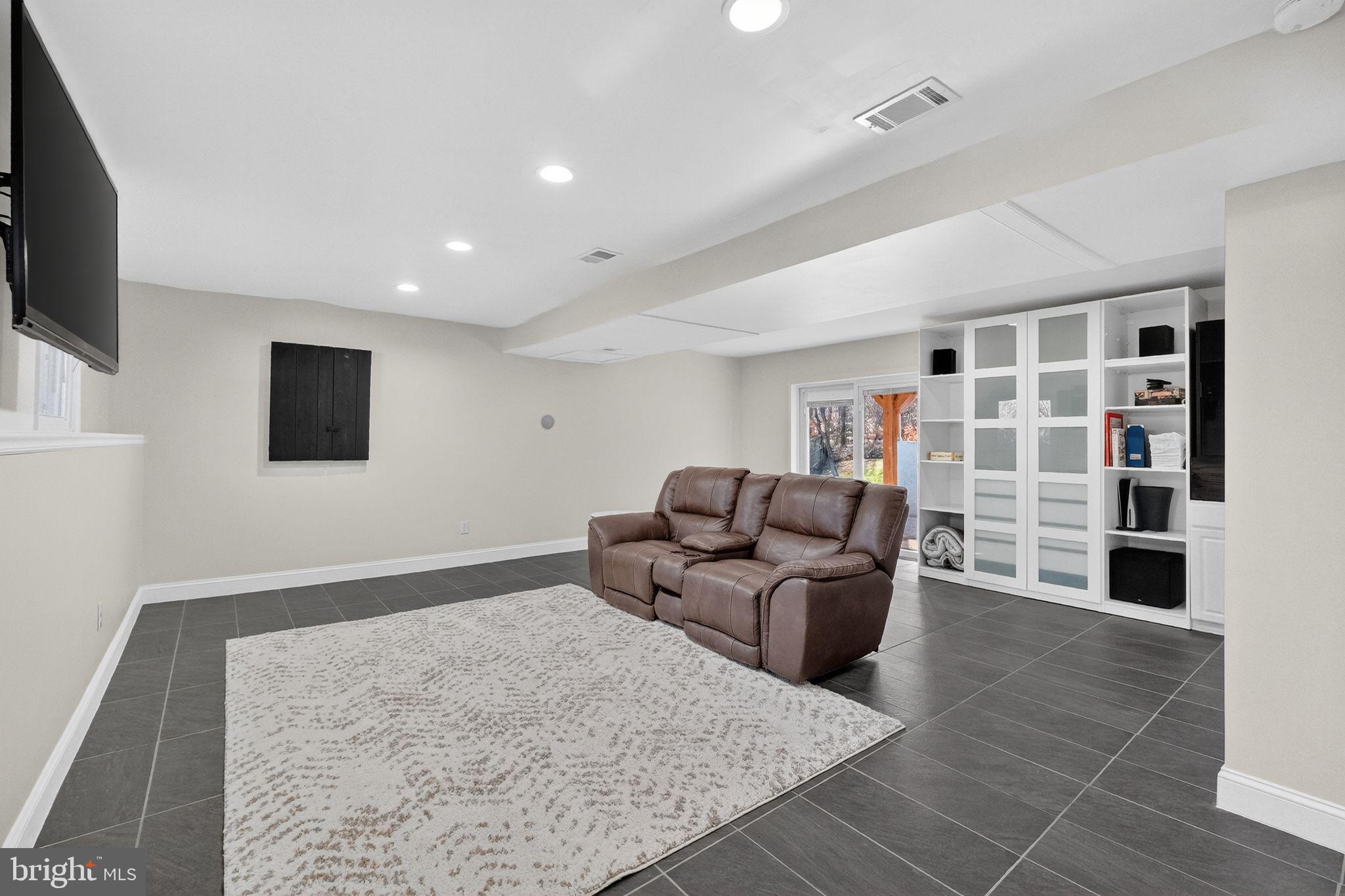 12608 Carland Place Laurel, MD 20708 - Photo 21 of 38 a living room with furniture and a flat screen tv