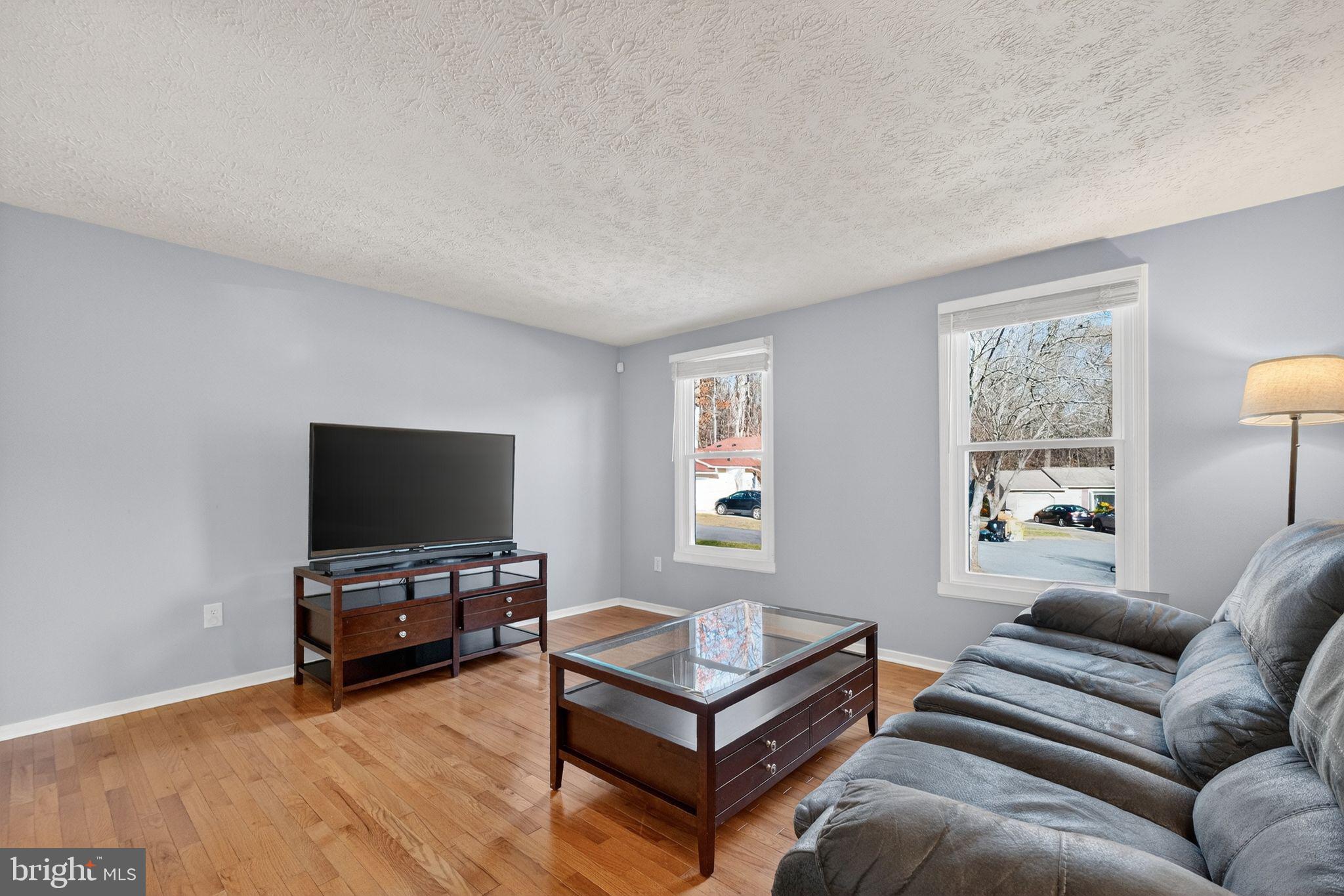 12608 Carland Place Laurel, MD 20708 - Photo 3 of 38 a living room with furniture and a flat screen tv