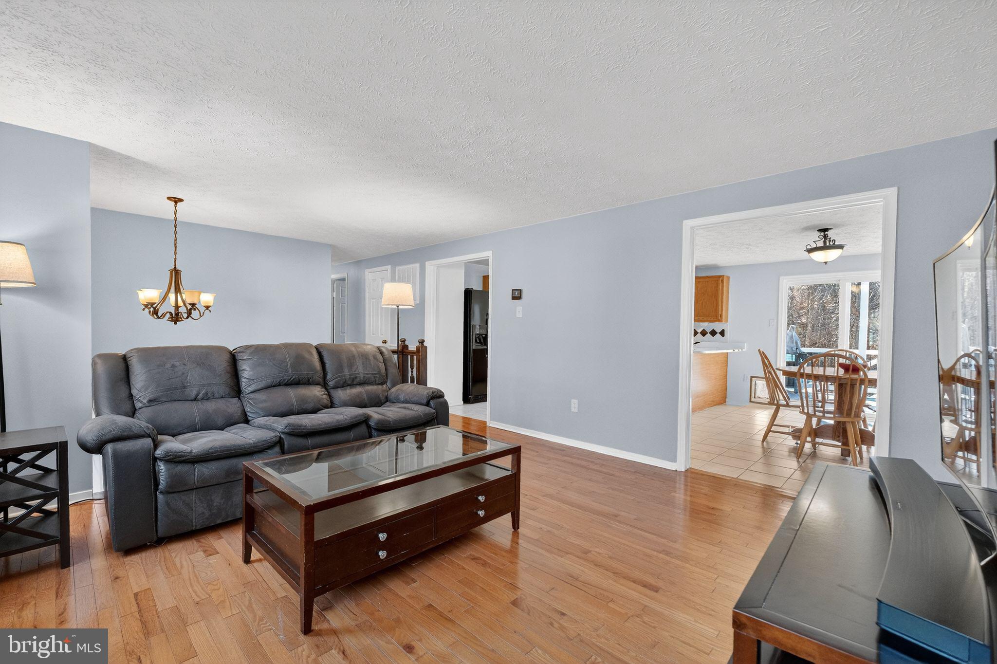 12608 Carland Place Laurel, MD 20708 - Photo 4 of 38 a living room with furniture and a wooden floor