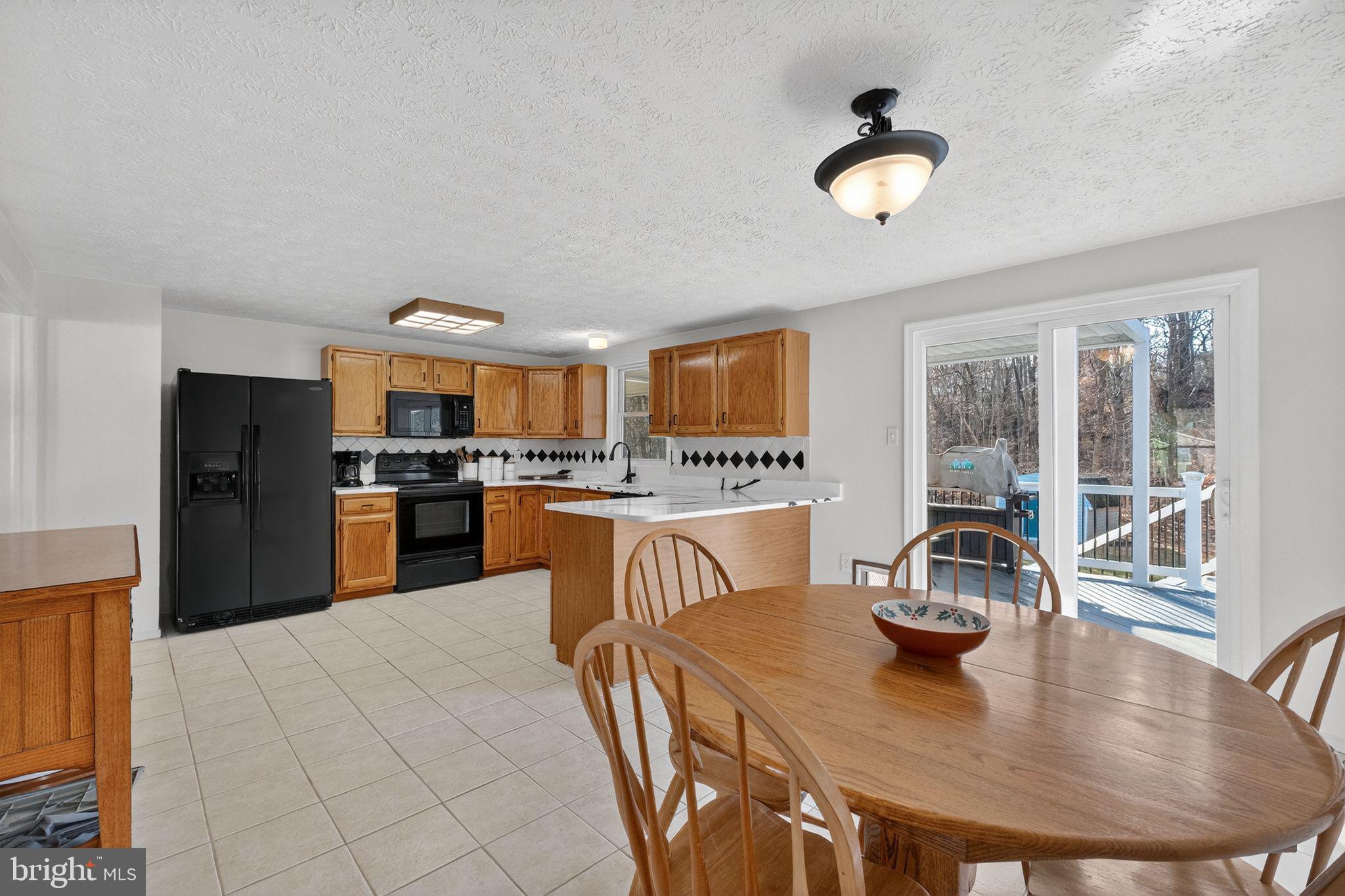 12608 Carland Place Laurel, MD 20708 - Photo 8 of 38 a kitchen with stainless steel appliances granite countertop a sink a stove and a refrigerator
