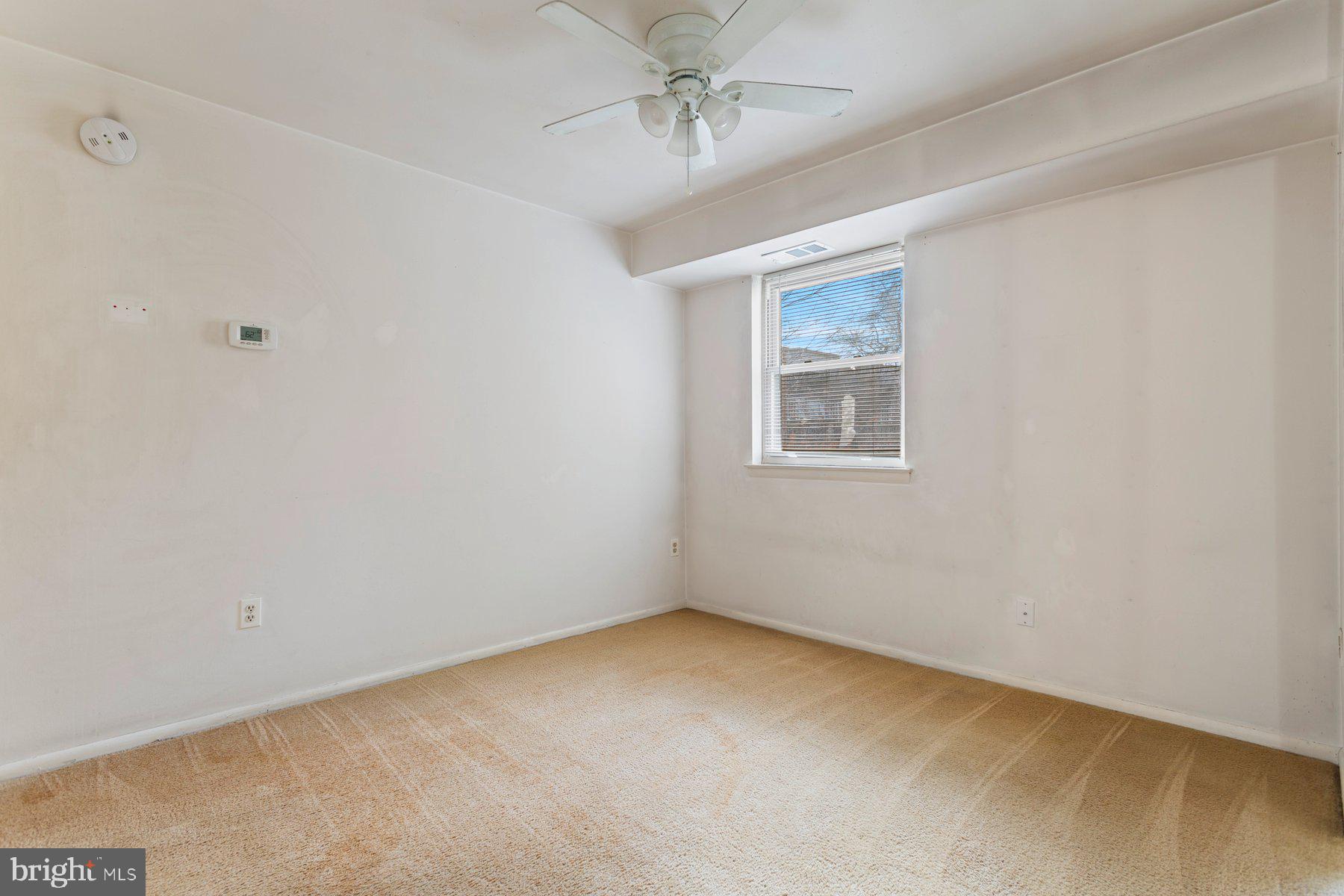 2305 Greenery Lane, Unit T43 Silver Spring, MD 20906 - Photo 11 of 30 an empty room with windows and fan