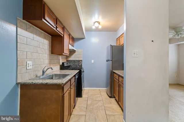a kitchen with a sink cabinets and a window