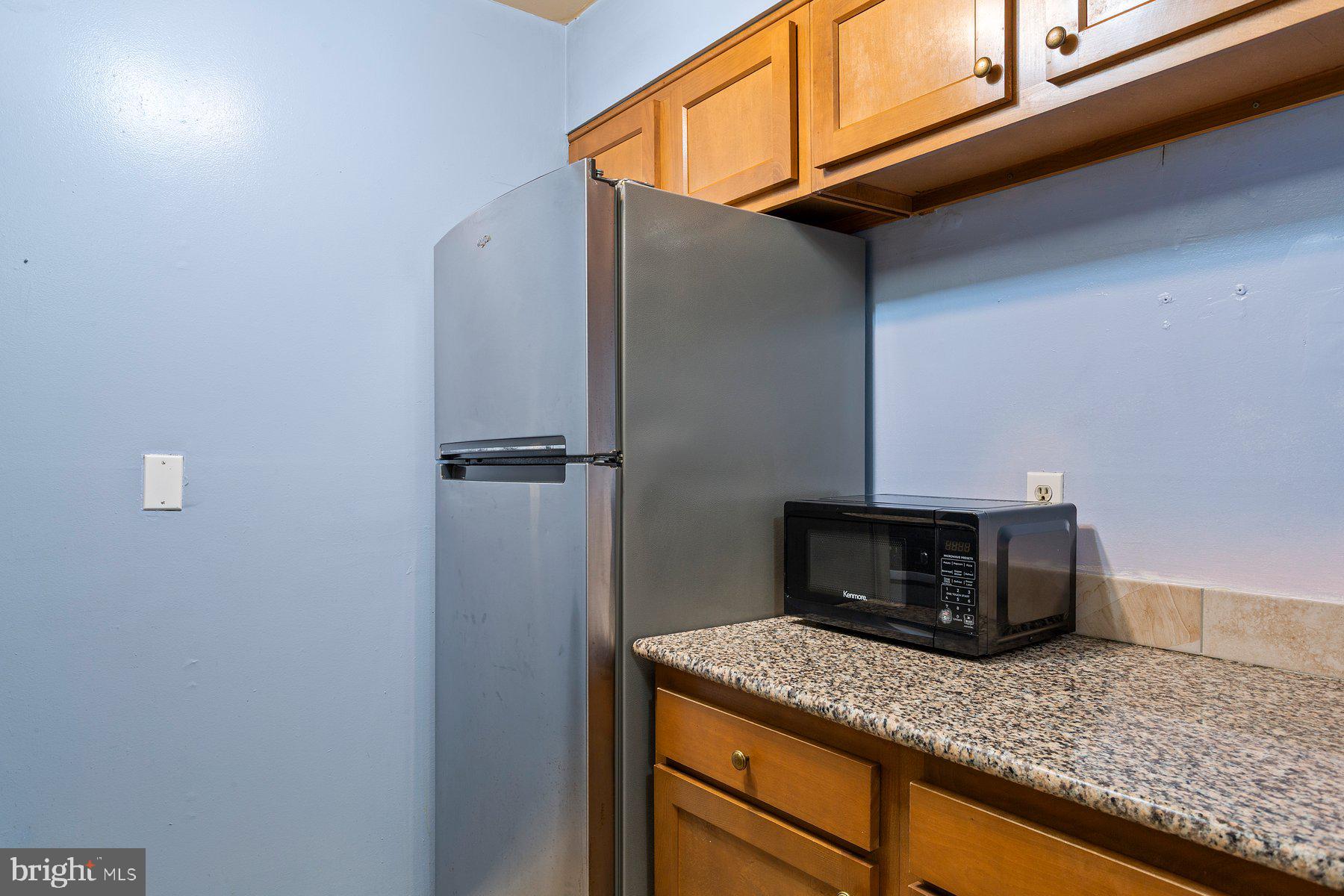 2305 Greenery Lane, Unit T43 Silver Spring, MD 20906 - Photo 18 of 30 a kitchen with a refrigerator and cabinets