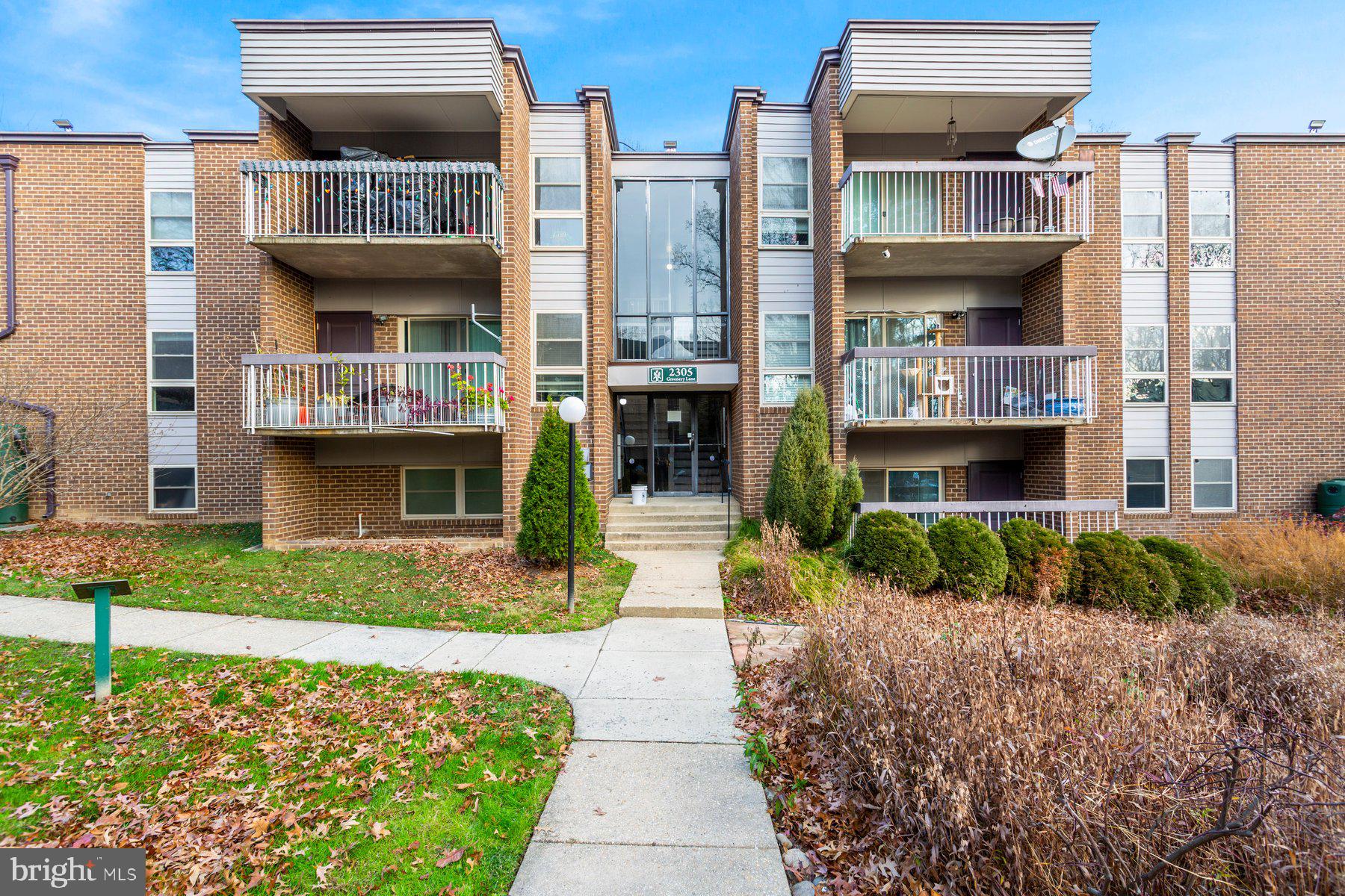 2305 Greenery Lane, Unit T43 Silver Spring, MD 20906 - Photo 30 of 30 a front view of multi story residential apartment building with a yard
