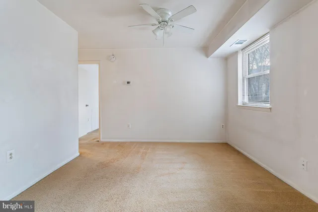 an empty room with a empty space and windows