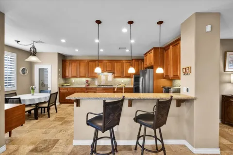 a large kitchen with a table and chairs