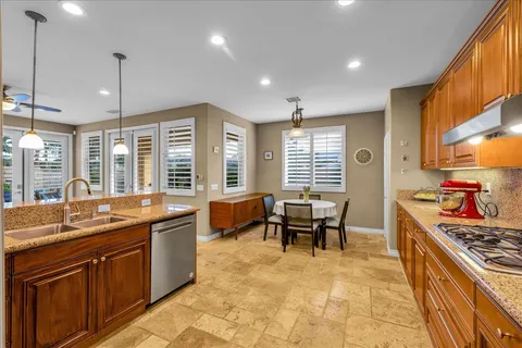 a kitchen with stainless steel appliances granite countertop sink stove and granite counter top