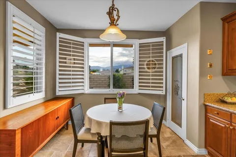 a dining room with furniture and window