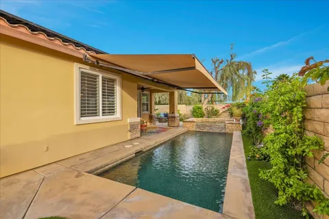 a view of a swimming pool with a patio