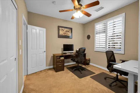 a spacious bathroom with a granite countertop sink a mirror and a shower