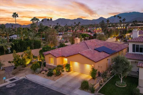 a balcony with chairs and table