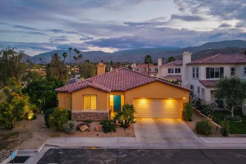 a view of a house with a garden and pathway