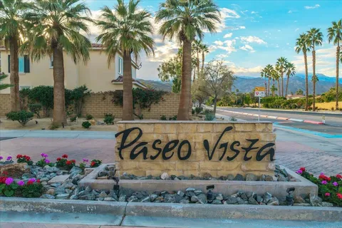 a view of pool with lawn chairs and iron fence