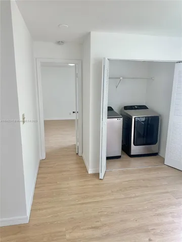 a view of a livingroom with wooden floor and furniture