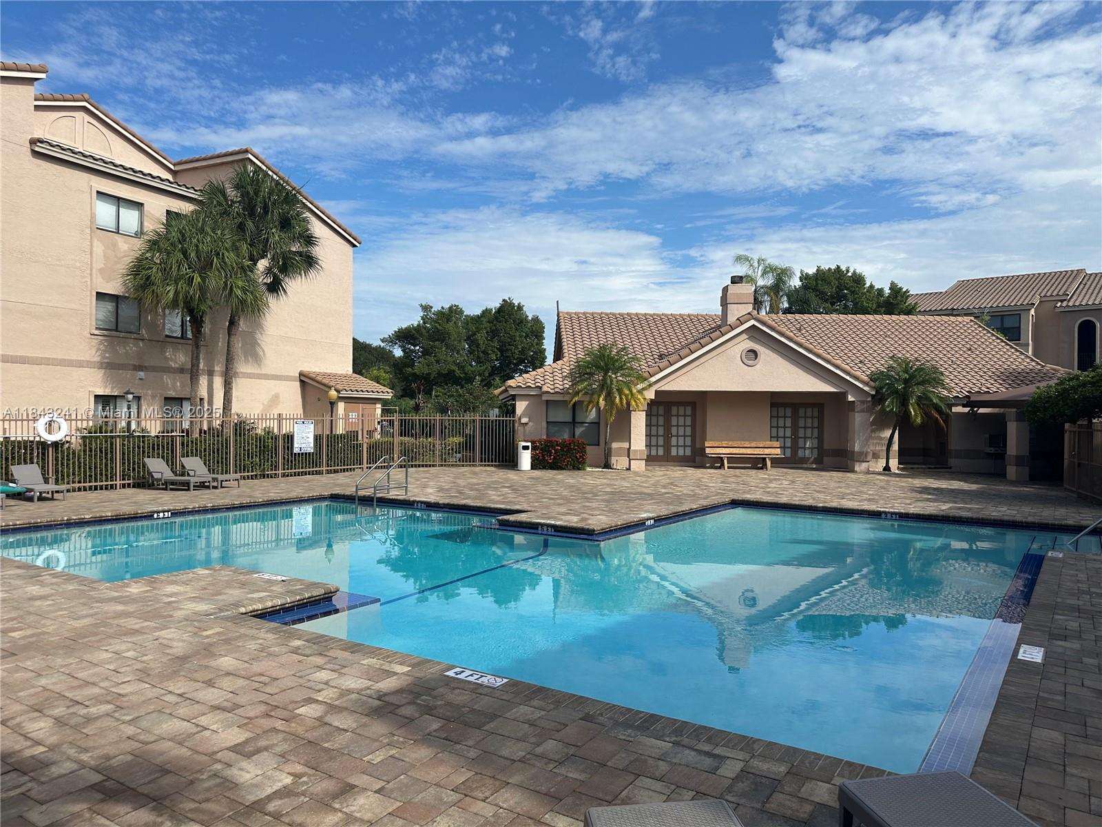 2846 South University Drive, Unit 4202 Davie, FL 33328 - Photo 5 of 17 a front view of a house with swimming pool having outdoor seating
