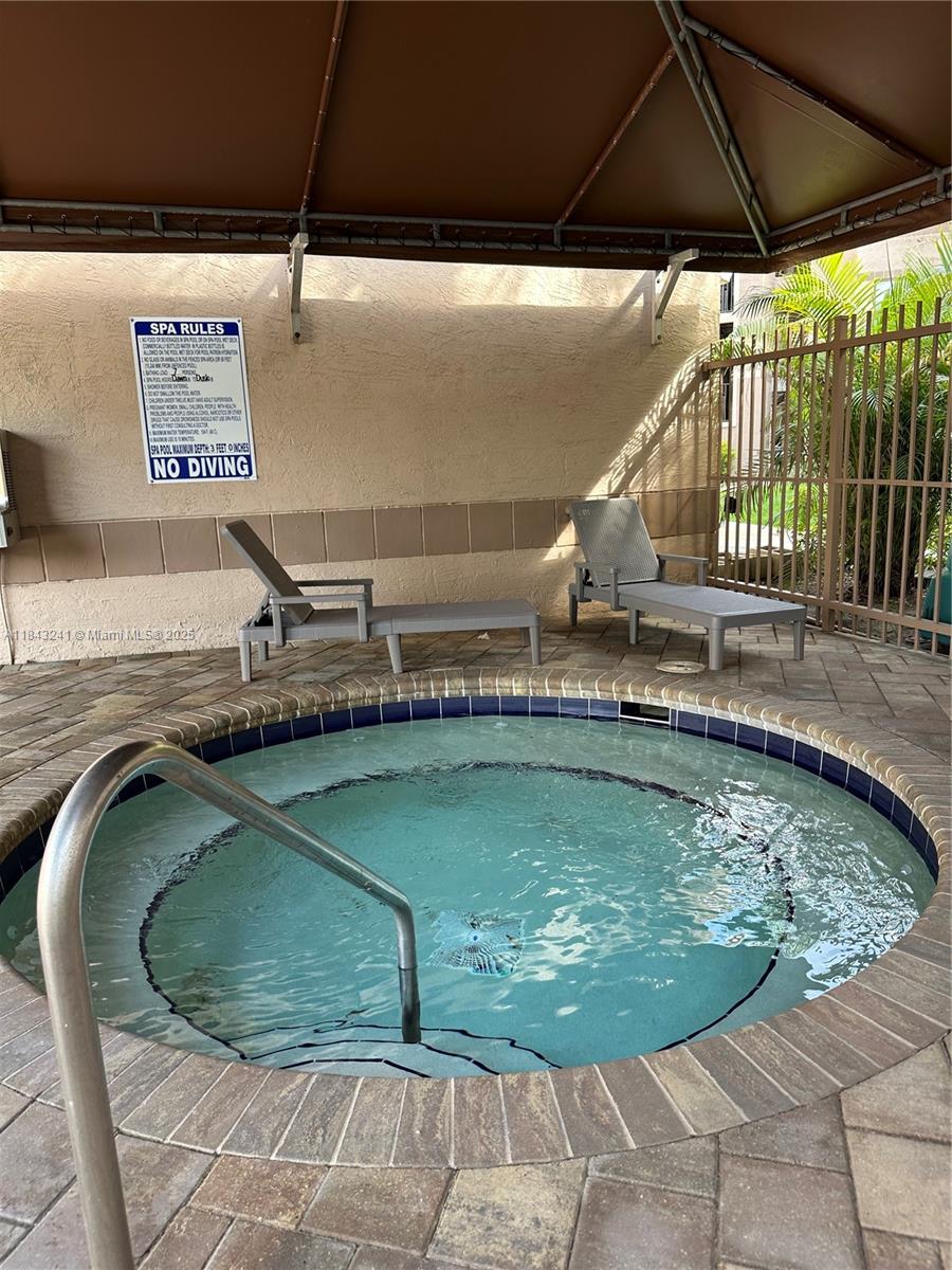 2846 South University Drive, Unit 4202 Davie, FL 33328 - Photo 6 of 17 a view of a swimming pool with a chair