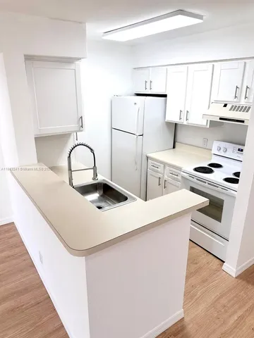 a kitchen with stainless steel appliances a sink stove and refrigerator