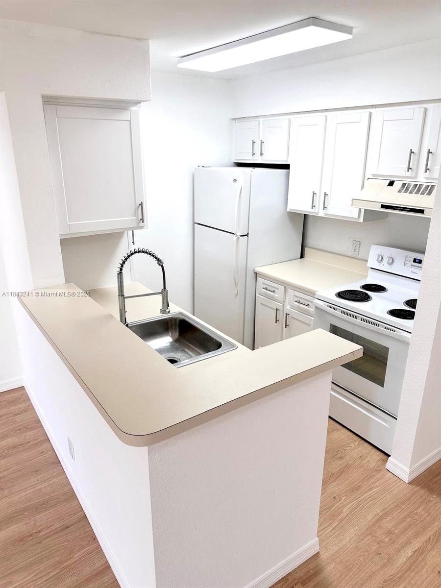 2846 South University Drive, Unit 4202 Davie, FL 33328 - Photo 7 of 17 a kitchen with stainless steel appliances a sink stove and refrigerator
