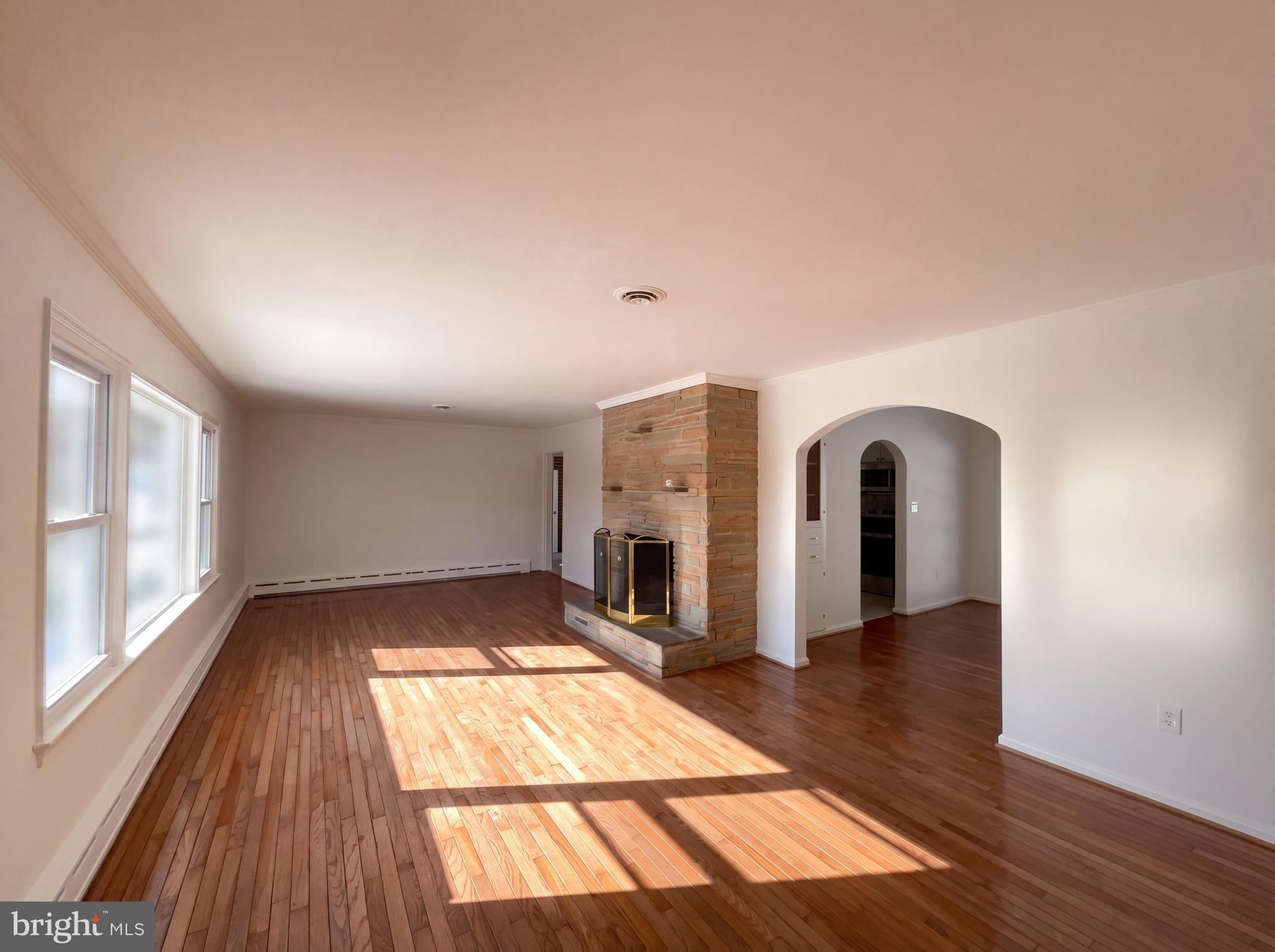 6048 Old Telegraph Road Alexandria, VA 22310 - Photo 13 of 43 wooden floor in an empty room with a fireplace